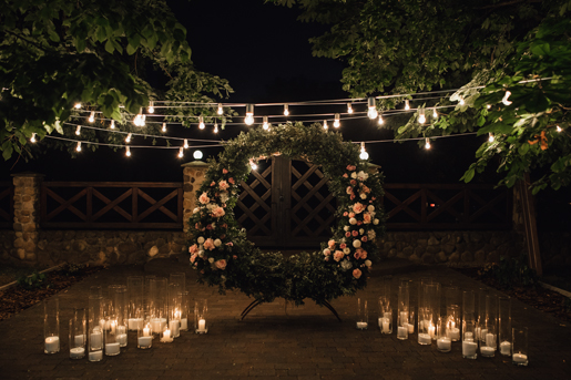 beautiful-photozone-with-big-wreath-decorated-with-greenery-roses-centerpiece-candles-sides-garland-hanged-trees.jpg
